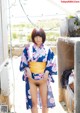 A woman in a kimono is posing for the camera.