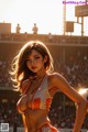 A woman in a bikini holding a soccer ball in front of a crowd.